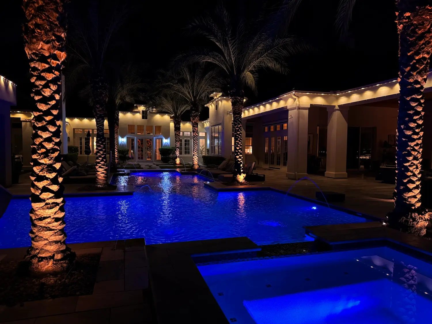 Evening home featuring custom LED eave lighting